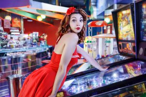 woman playing pinball machine