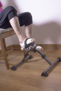 senior woman using pedal exerciser